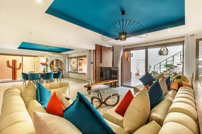 a living room with a large couch with colorful pillows at Villa Serenity & SPA - Breakfast in Marrakech