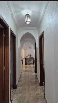 an empty hallway with a chandelier in a house at Lala's apartment in Marrakech
