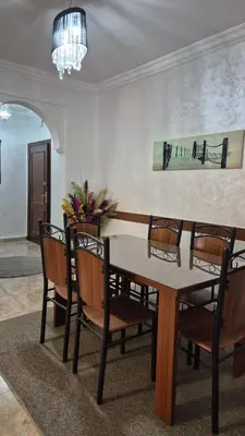 a dining room with a table and chairs at Lala's apartment in Marrakech