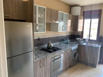 a kitchen with a refrigerator and a washer and dryer at Luxury, Cosy Apartement (Wifi, Balcony, Parking) in Marrakech