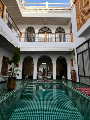 a courtyard with a pool in a building at Riad Darchica in Marrakech