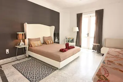 a bedroom with a large bed with red shoes on it at Riad avec piscine - Wifi- petit déjeuner - Bon Emplacement in Marrakech