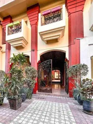 an entrance to a building with a gate and plants at superbe appartement à Gueliz in Marrakech