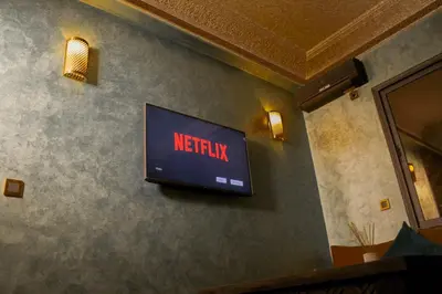 a television on a wall with a netflix sign on it at Appartement style Riad, 2 chambres, ambiance cosy in Marrakech
