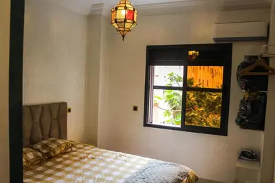 a bedroom with a bed and a window at Appartement style Riad, 2 chambres, ambiance cosy in Marrakech