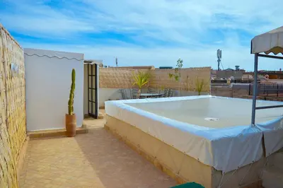 a hot tub sitting on top of a patio at Charming riad in the medina of Marrakech with 4 nice rooms in Marrakech