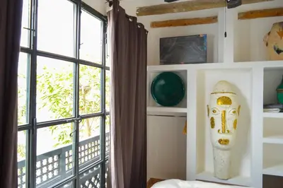 a bedroom with a window and a mask on the wall at Charming riad in the medina of Marrakech with 4 nice rooms in Marrakech