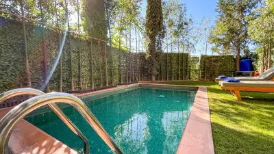 a swimming pool in a backyard with a fence at Villa Atlas piscine chauffée à Marrakech in Marrakech