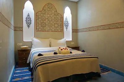 a bedroom with a large bed with arerorerorero at Flowers riad in Marrakech