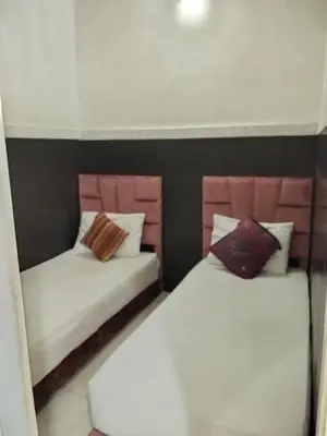 two beds in a room with white and pink at DAR IJLAL in Marrakech