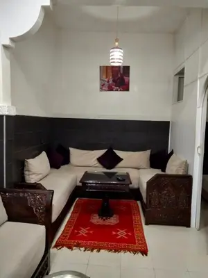 a living room with a couch and a table at DAR IJLAL in Marrakech