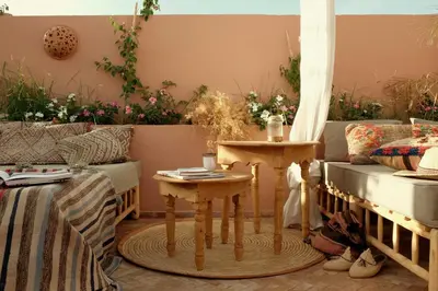a living room with two tables and a couch at Riad BE Marrakech in Marrakech
