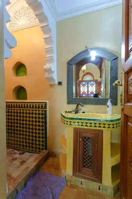 a bathroom with a sink and a mirror at Riad Tranquility - A Timeless Marrakech Haven in Marrakech
