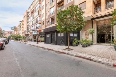 an empty city street with a tree and buildings at New! Appartement Diana calme ,Terrasse in Marrakech