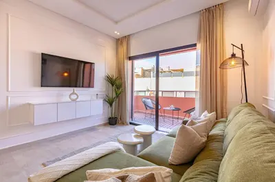 a living room with a couch and a tv at New! Appartement Diana calme ,Terrasse in Marrakech
