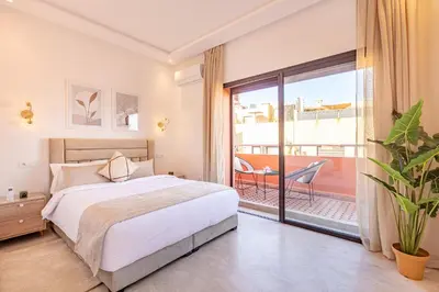 a bedroom with a bed and a balcony at New! Appartement Diana calme ,Terrasse in Marrakech