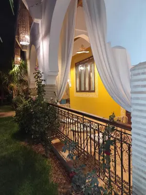 a house with a balcony with a fence at Riad Safran Ralya in Marrakech