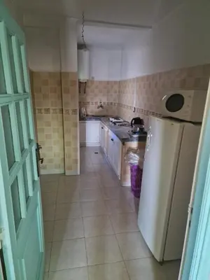 a kitchen with a white refrigerator and a stove at appartement sympathique à Marrakech in Marrakech