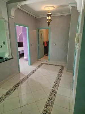 a hallway with a tile floor and a chandelier at appartement sympathique à Marrakech in Marrakech