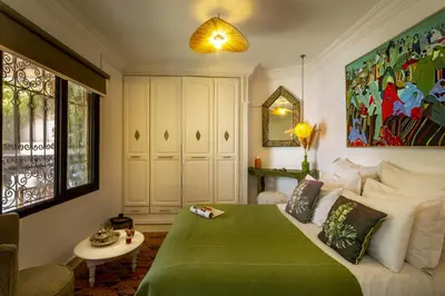 a bedroom with a bed with a green blanket at Villa Cosy Piscine Proche centre-ville 4 suites in Marrakech