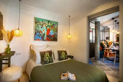 a bedroom with a bed and a painting on the wall at Villa Cosy Piscine Proche centre-ville 4 suites in Marrakech