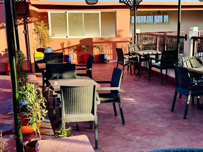 a restaurant with chairs and tables and tables and chairs at Riad hotel Cecil in Marrakech