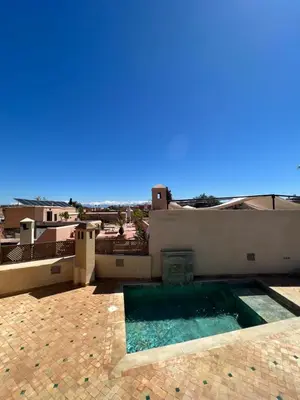a swimming pool on the roof of a house at Riad Jnan El Cadi in Marrakech