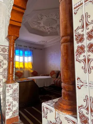 a living room with a bed and a mirror at Stylish Moroccan Apartment Near Marrakech Airport in Marrakech