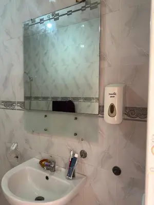 a bathroom with a sink and a mirror at Stylish Moroccan Apartment Near Marrakech Airport in Marrakech