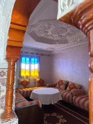 a living room with couches and a table at Stylish Moroccan Apartment Near Marrakech Airport in Marrakech
