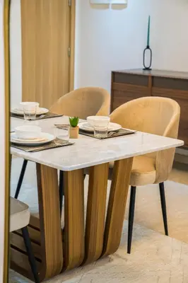 a table with two chairs and a table with glasses on it at TheCasaEdition - Gueliz Apartments in Marrakech