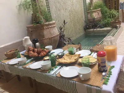 a table with food and drinks on top of it at Riad Dar Jdati in Marrakech