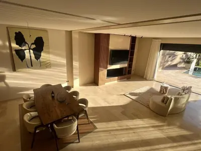a living room with a wooden table and chairs at LUXURY Villa Argane 5 BDR -ONLY FAMILYS in Marrakech