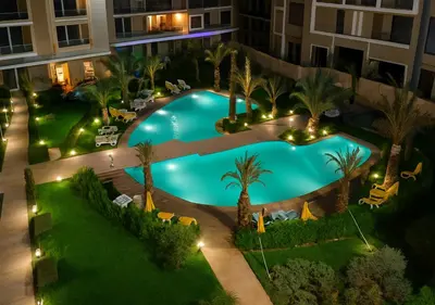 an overhead view of a swimming pool at night at Pearl Garden 69 in Marrakech
