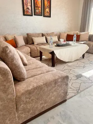 a living room with a couch and a coffee table at LUXURY APPART Pool view Riad Garden in Marrakech