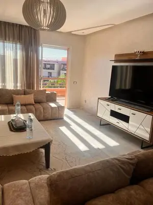 a living room with a large flat screen tv at LUXURY APPART Pool view Riad Garden in Marrakech