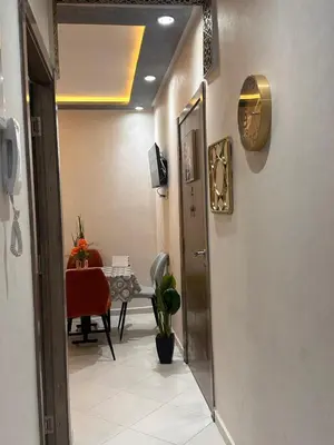 a hallway with a room with a table with a chair at Charmant Appartement 2 Chambres pour Sejours en Famille Marrakech in Marrakech