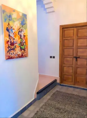 a room with a door and a painting on the wall at Riad Orient Palace in Marrakech