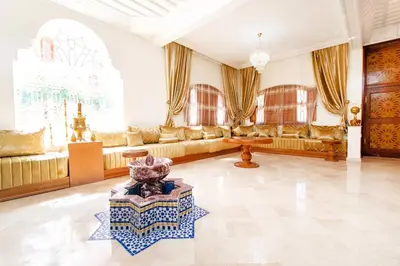 a large living room with couches and a table at Zine Villa Guest House in Marrakech