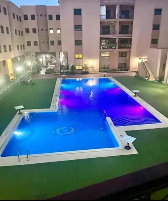 a large swimming pool in the middle of a building at Chez Alex in Marrakech