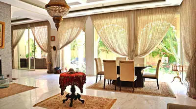 a dining room with a table and chairs at Barthélemy Guest House in Marrakech