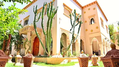a building with a cactus in front of it at Barthélemy Guest House in Marrakech