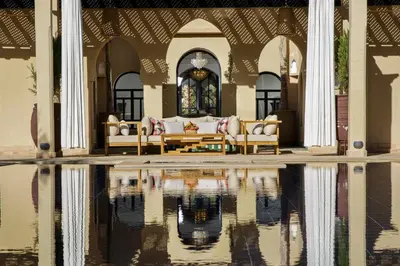 a house with a reflection in a pool of water at Dar Banati Palmeraie in Marrakech
