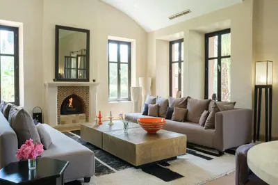 a living room with a couch and a fireplace at Villa Jennabelle in Marrakech