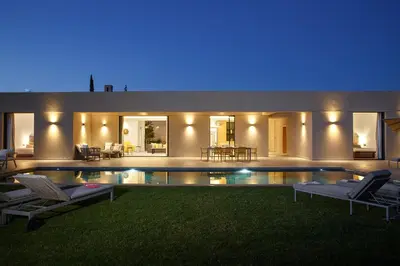 a house with a swimming pool at night at ADA ADA modern villa with heated private pool next city center in Marrakech