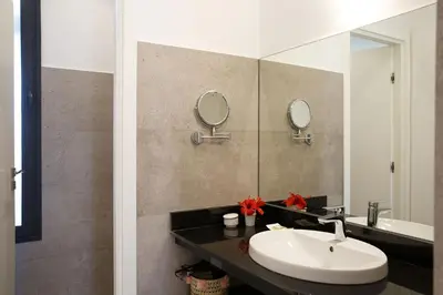 a bathroom with a sink and a mirror at ADA ADA modern villa with heated private pool next city center in Marrakech