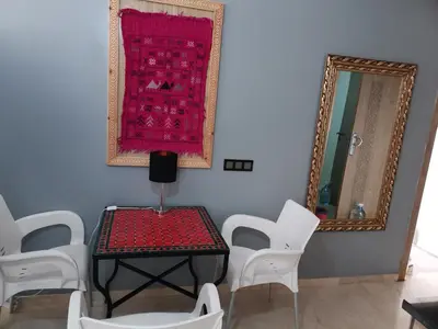 a room with a table and chairs and a red rug at B1 In Center of Marrakech, Geliz-Majorelle, Bab-Dokala, No need for Taxi in Marrakech