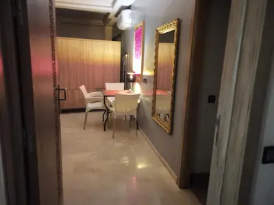 a dining room with a table and chairs and a mirror at B1 In Center of Marrakech, Geliz-Majorelle, Bab-Dokala, No need for Taxi in Marrakech
