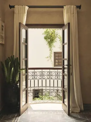 an open door to a balcony with a window at IZZA Marrakech in Marrakech