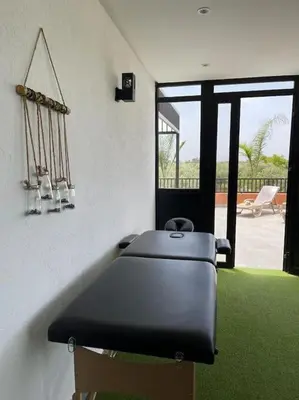 a room with a bench in a room with grass at Villa Amèle,calme,Ensoleillé,Piscine,Salle de jeux in Marrakech